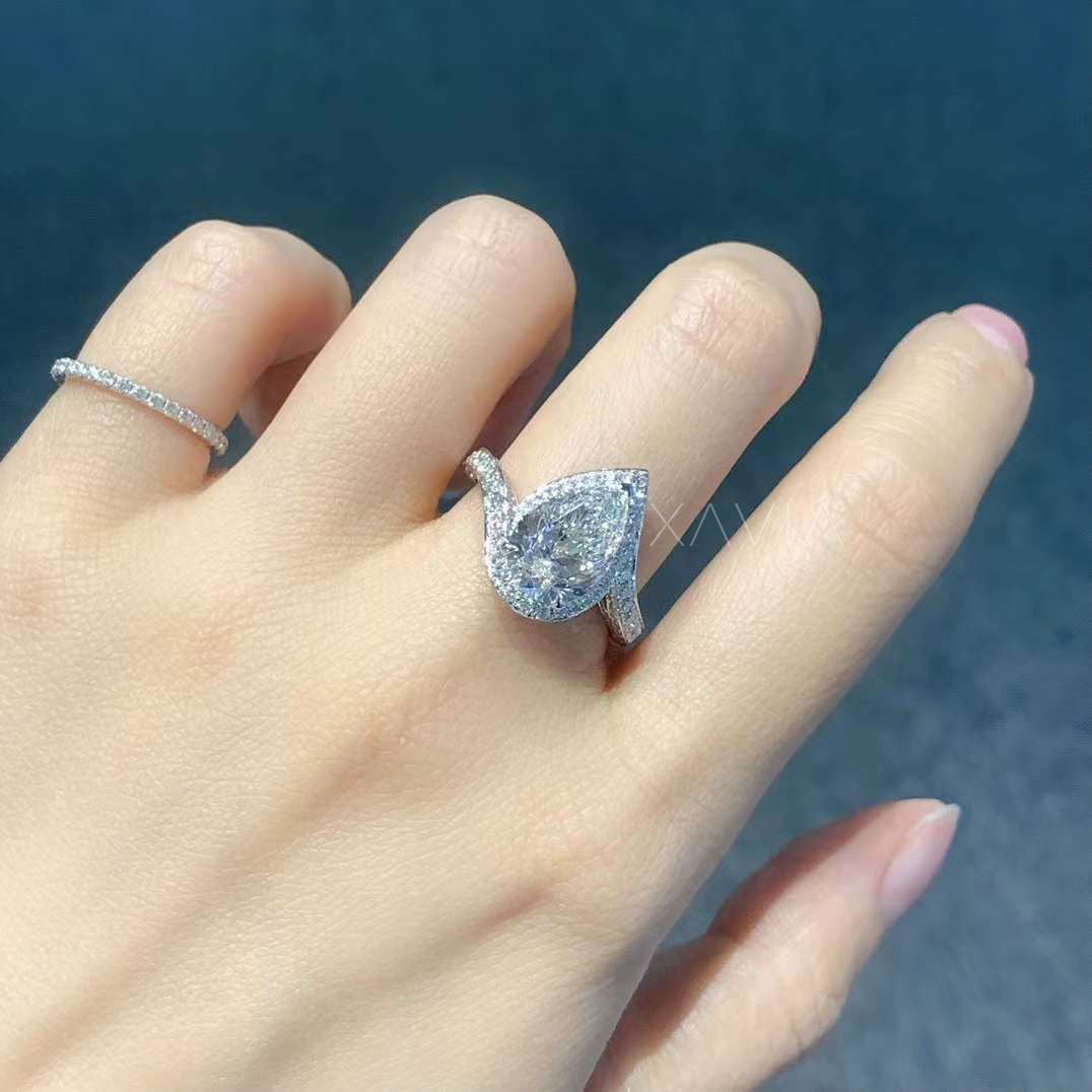 pear cut lab diamond halo ring worn on hand