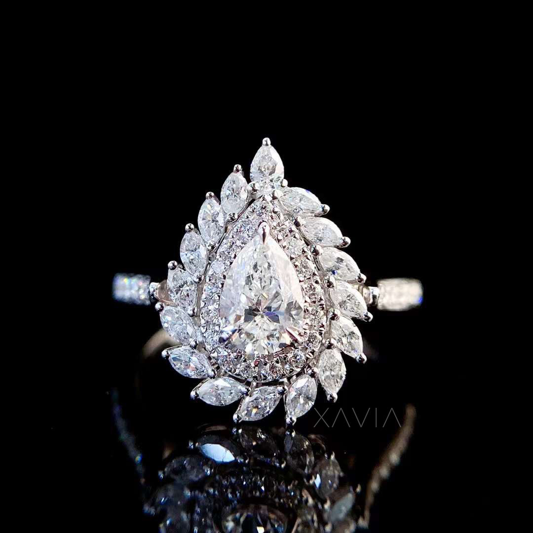 top view of pear shaped lab grown diamond ring highlighting marquise and round halo symmetry and fine pavé detailing