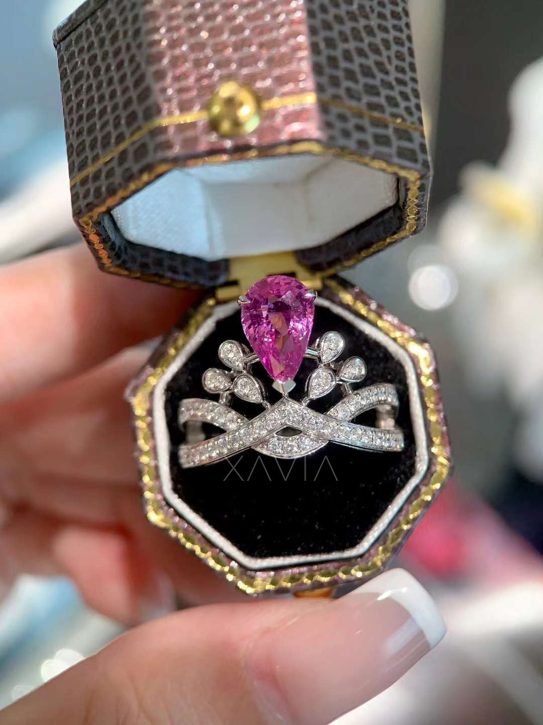 pear cut lab grown pink diamond engagement ring displayed in luxury box with marquise floral halo and pavé twisted band