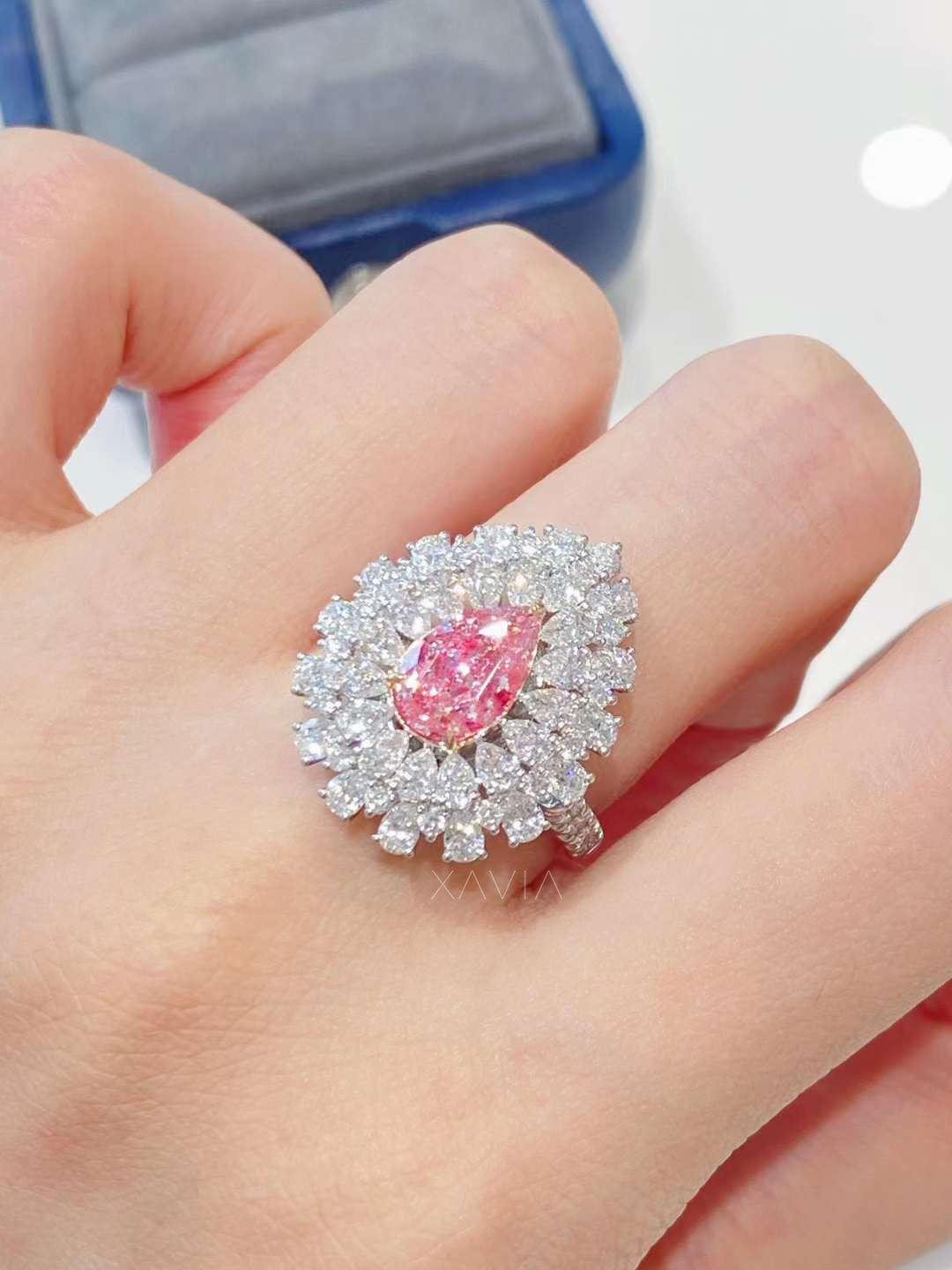 Pear shaped pink lab diamond halo ring worn on hand highlighting elongated silhouette, double halo brilliance, and luxury craftsmanship