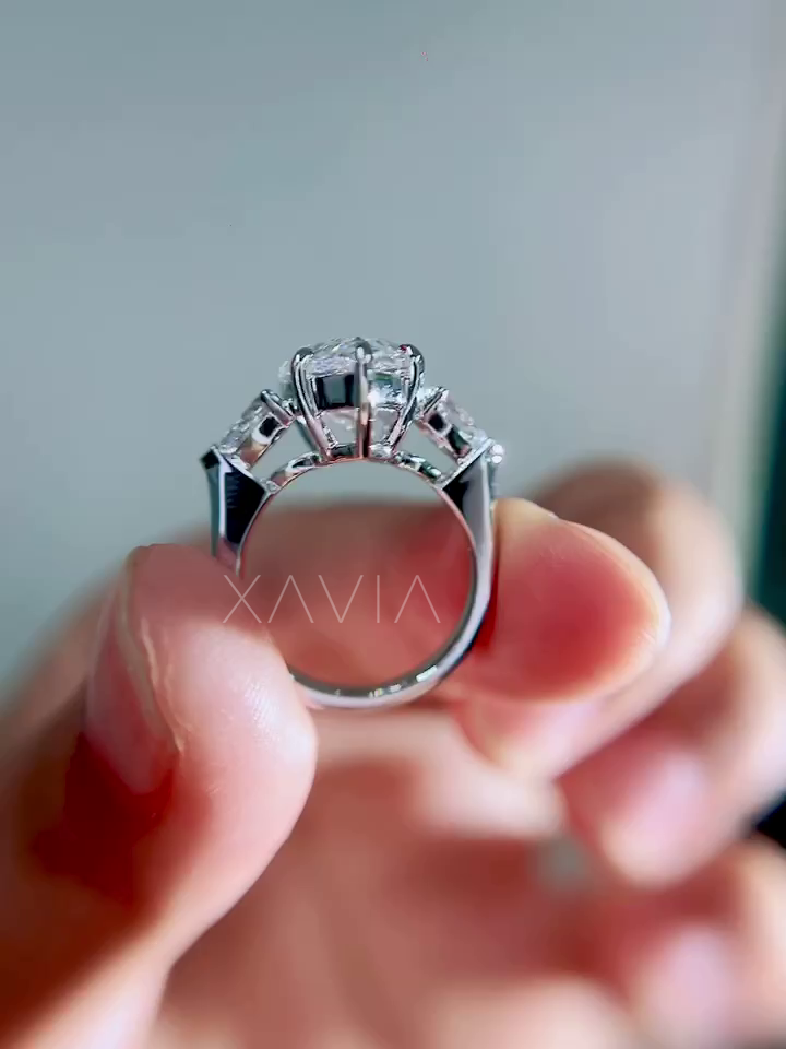  rear gallery view of pear cut lab grown diamond engagement ring showing elevated prong structure and triangular trillion side stones