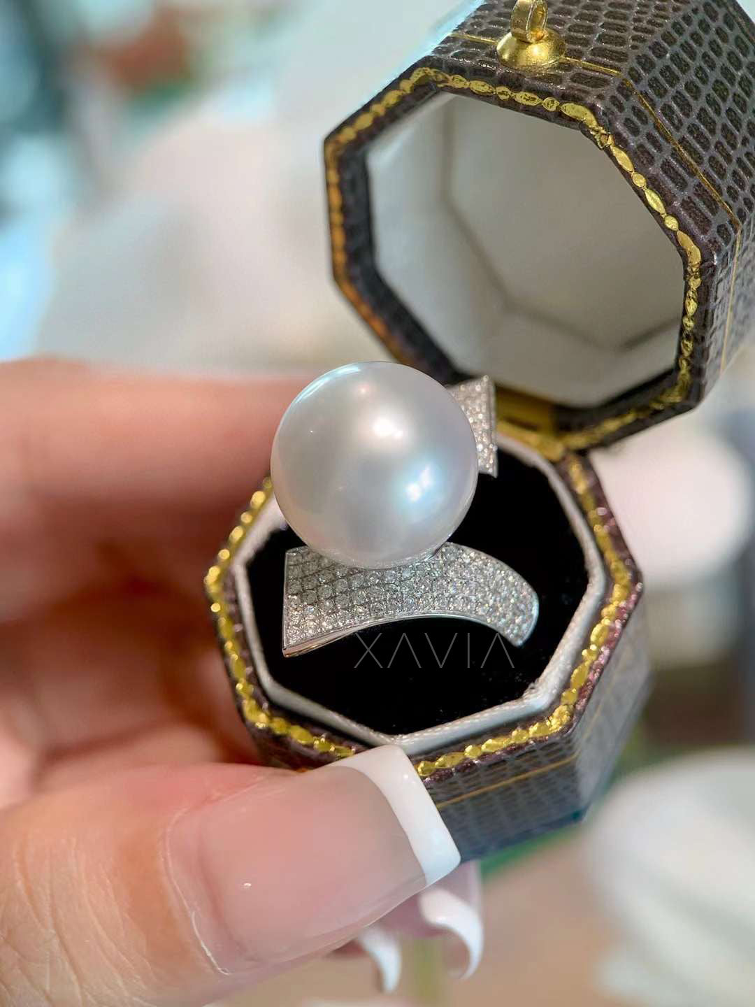 Front profile of pearl diamond cocktail ring highlighting geometric pavé diamond shoulders and open-frame architectural design
