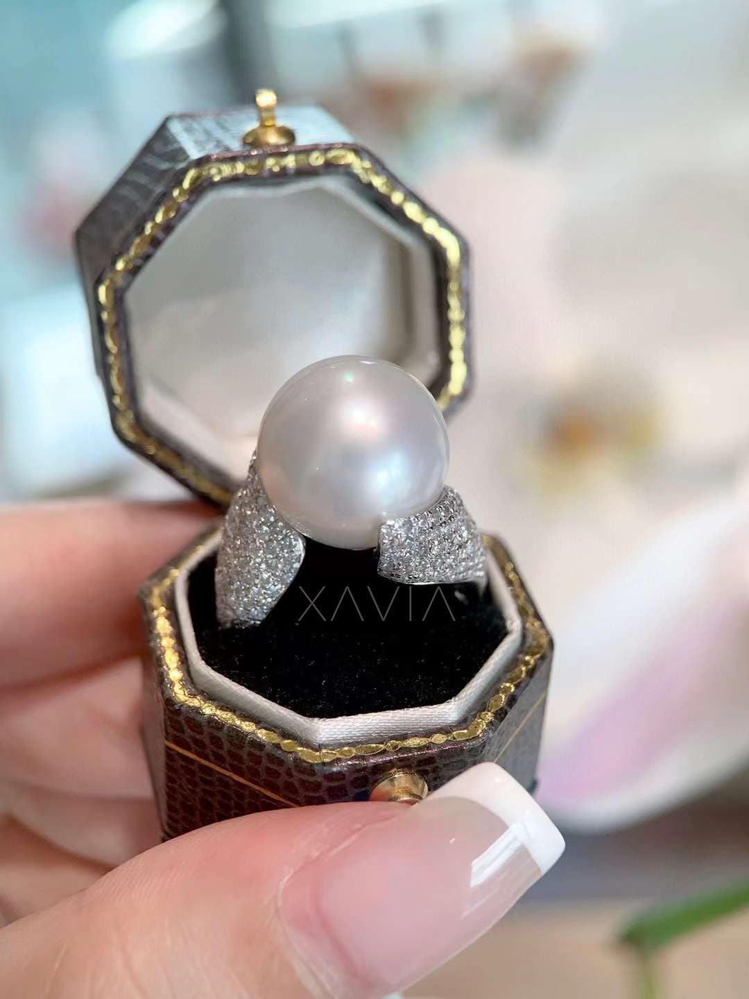 front view of round pearl bypass ring featuring pavé lab-grown diamonds on sculpted shoulders and smooth polished precious metal band