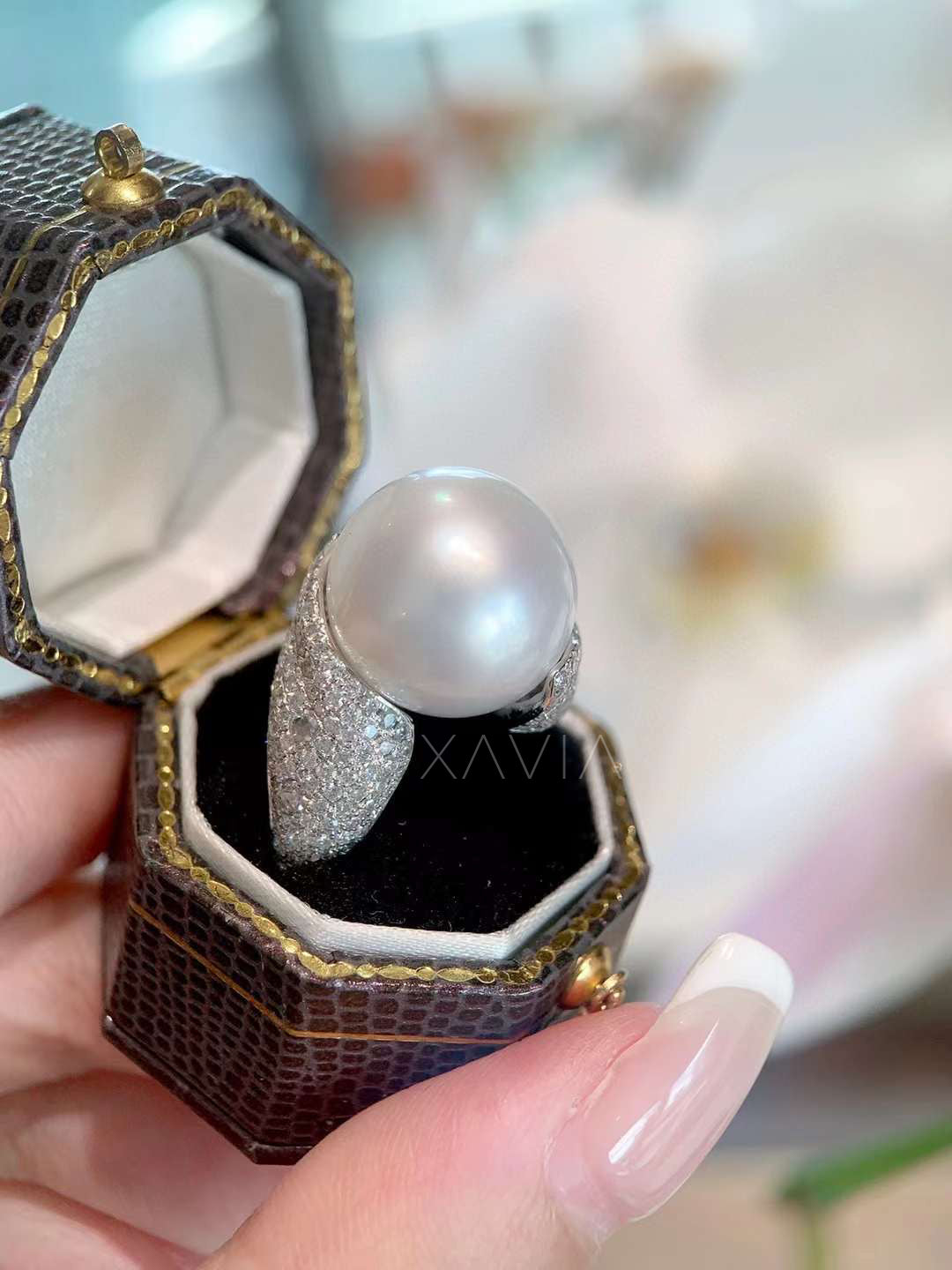 angled side profile of pearl diamond statement ring showing pavé diamond setting, curved bypass design, and refined high-polish finish
