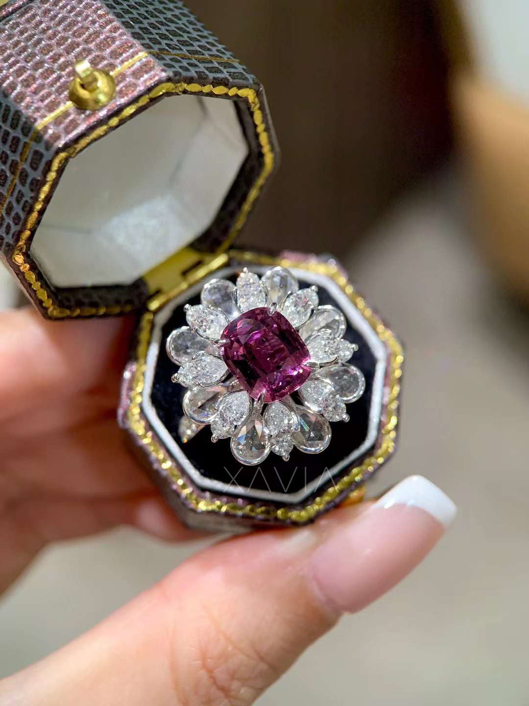 Luxury pink cushion diamond cocktail ring displayed inside jewelry presentation box highlighting floral pear diamond halo design and brilliant reflections