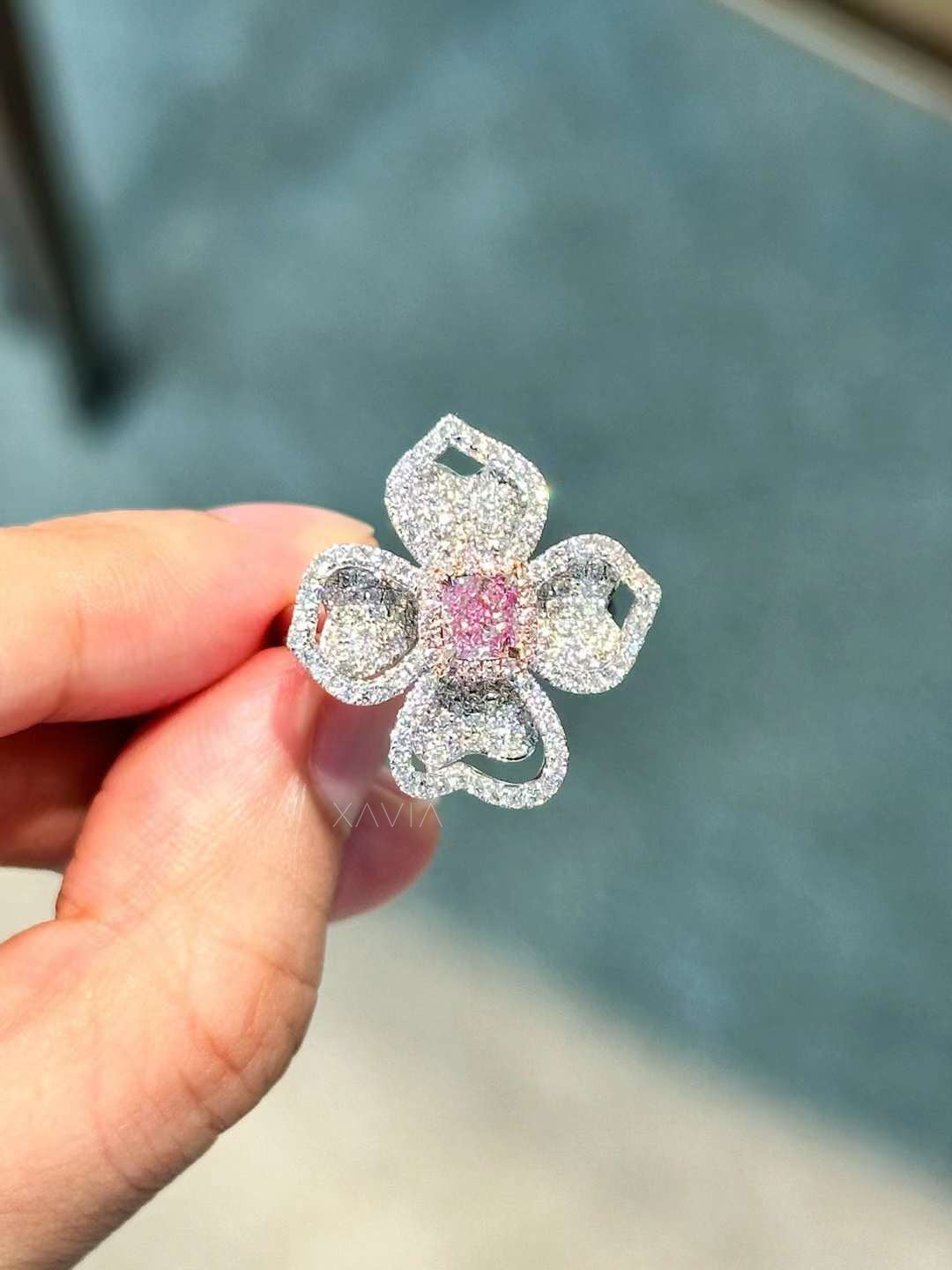 close-up of Petralisse floral cocktail ring with pink lab-grown diamond center and pavé diamond petals in white gold