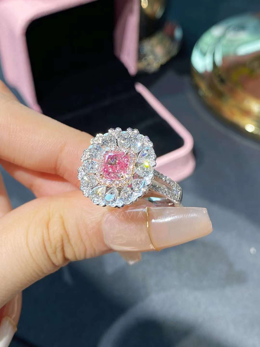 elegant cushion pink diamond halo engagement ring with white diamond floral halo shown in jewelry box