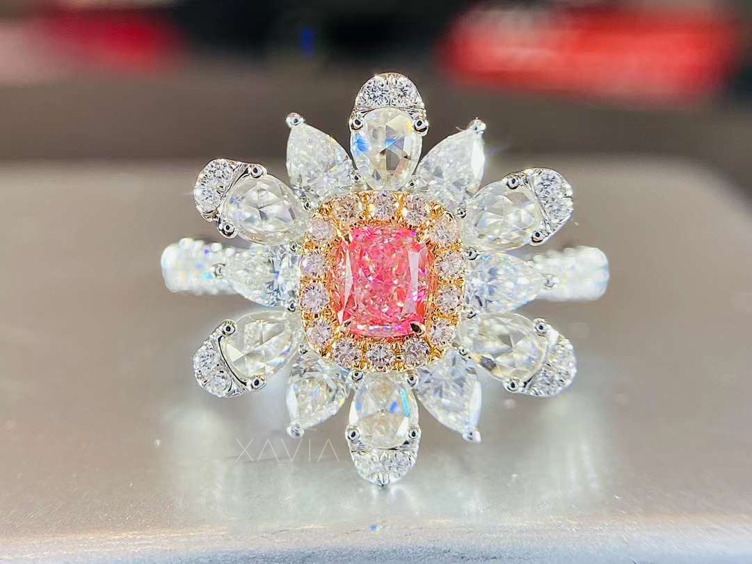 Pink cushion lab diamond floral halo engagement ring worn on hand showing scale, sparkle, and petal cluster design