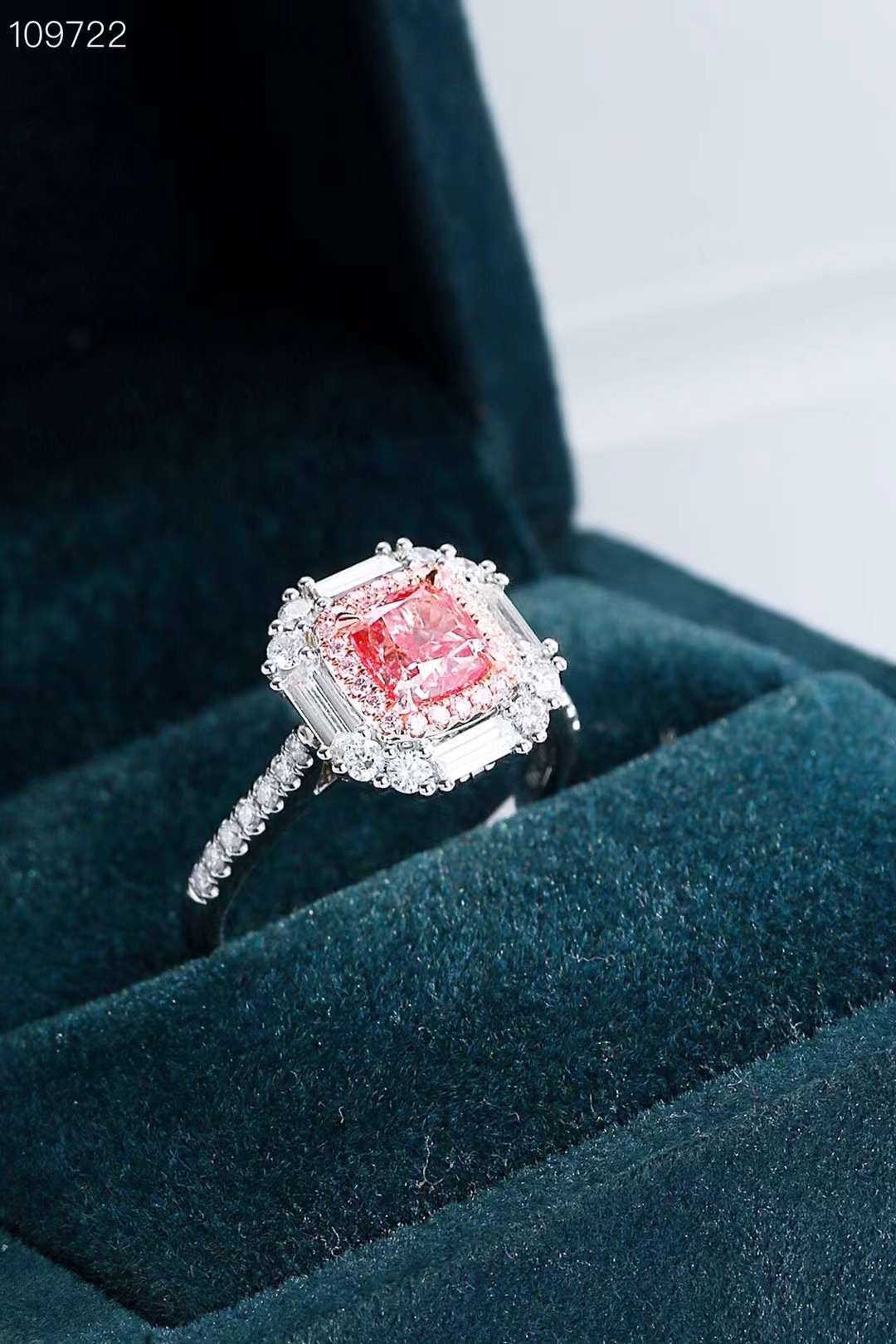 side angle of pink diamond engagement ring in green velvet box