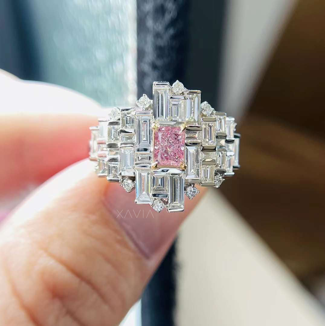 close-up of radiant pink emerald diamond ring with geometric baguette cluster and white diamond accents