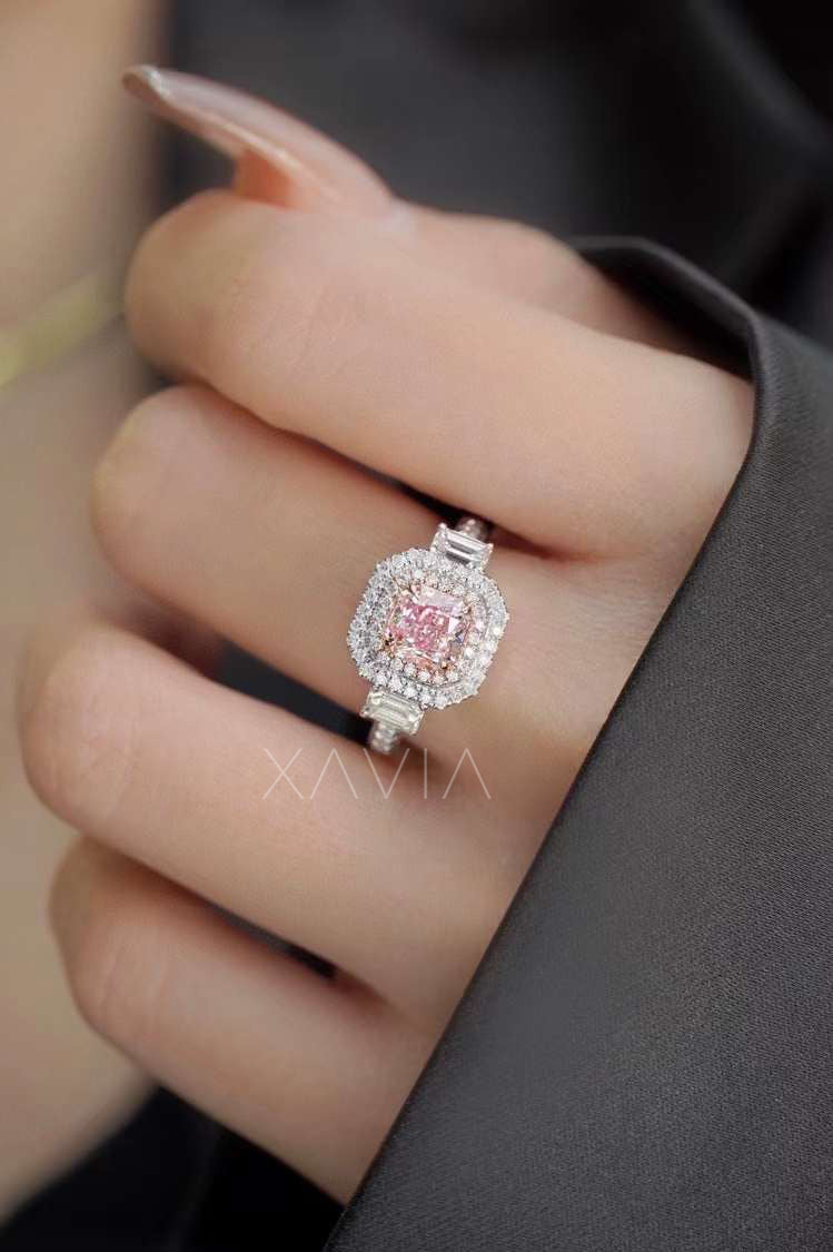 radiant cut pink diamond ring with double halo worn on model's finger