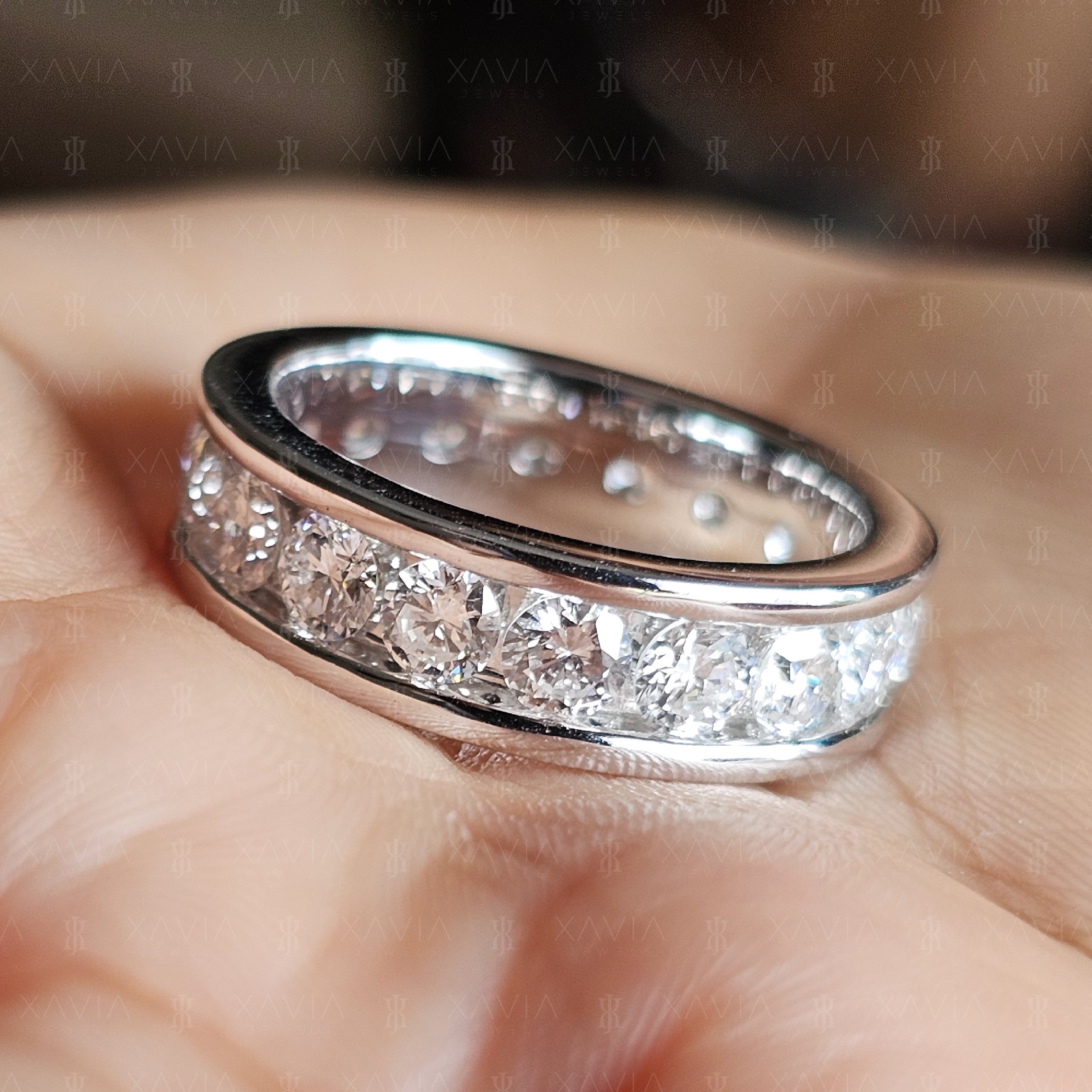 Close-up photograph of polished channel-set eternity ring featuring bright round lab-grown diamonds and sleek architectural silhouette