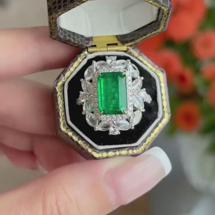 Verdant Empress Bloom – Emerald Cut Green Gemstone Cocktail Ring with Floral Marquise Diamond Halo and Pavé Frame Statement Ring