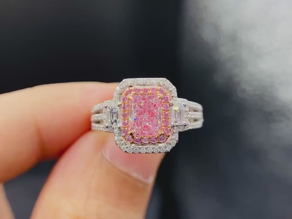 closeup view of pink diamond lab engagement ring with pavé double halo and geometric baguette side stones
