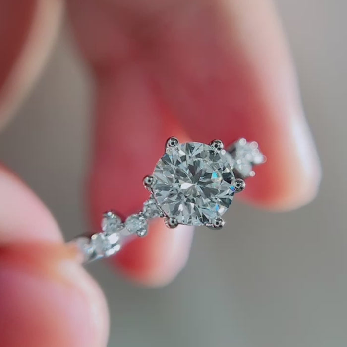 Round brilliant DEF color lab-grown diamond center with VVS–VS clarity, accented by marquise and round diamonds on an elegant nature-inspired vine band.