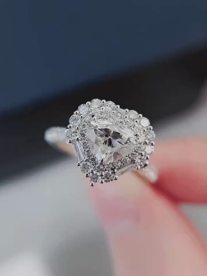 GIA-style heart cut lab-grown diamond center surrounded by brilliant round halo and tapered baguette accents, available in premium solid gold or platinum.