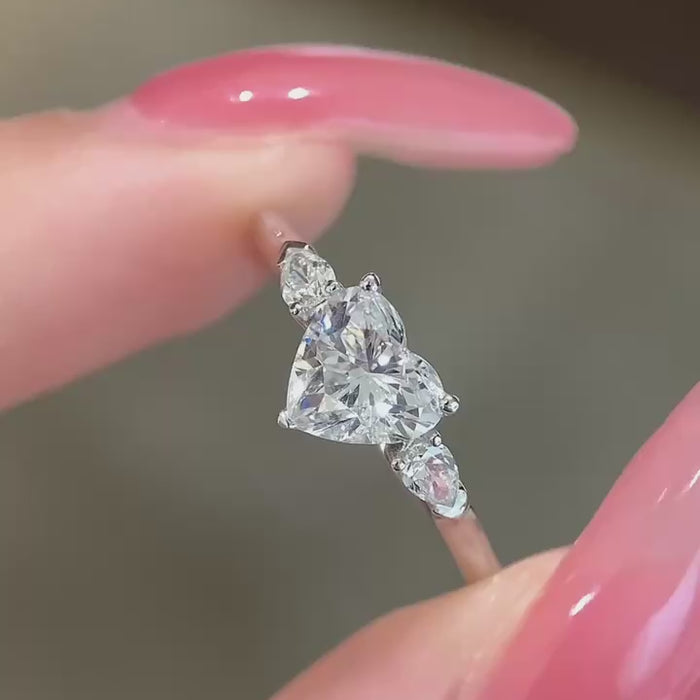Heart-cut DEF color lab-grown diamond center with pear-shape side diamonds, VVS–VS clarity, available in 14K or 18K gold and platinum engagement ring.