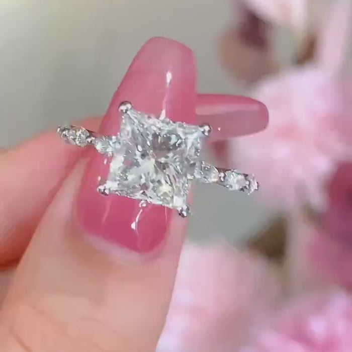 Princess cut lab-grown diamond engagement ring with DEF color VVS/VS clarity center stone, marquise accent band, available in platinum or solid gold.