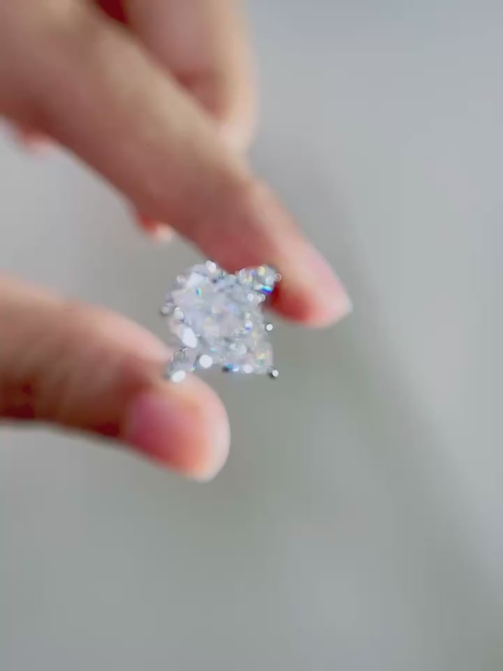 Elegant pear cut lab-grown diamond engagement ring featuring trillion side diamonds, DEF color VVS/VS clarity, customizable center stone weights in solid gold or platinum.