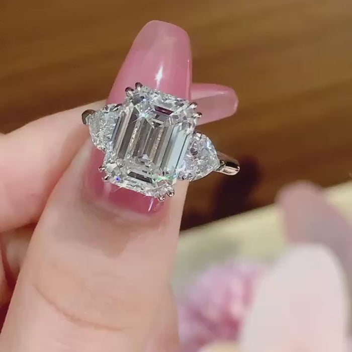 Emerald cut lab-grown diamond engagement ring featuring DEF color VVS/VS clarity center stone with trillion side diamonds in handcrafted white gold or platinum setting.