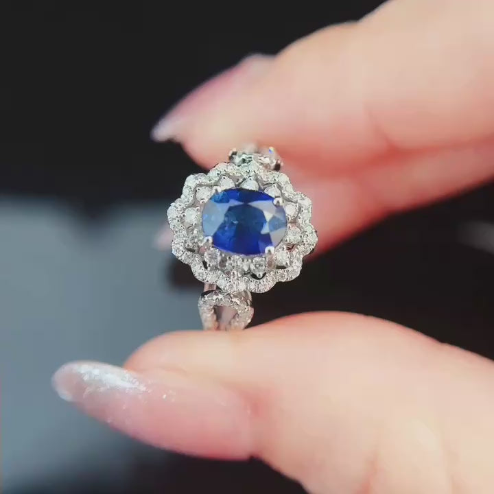 Oval-cut royal blue sapphire center framed by brilliant lab-grown diamond floral halo, pavé split shank band, handcrafted in solid gold or platinum.