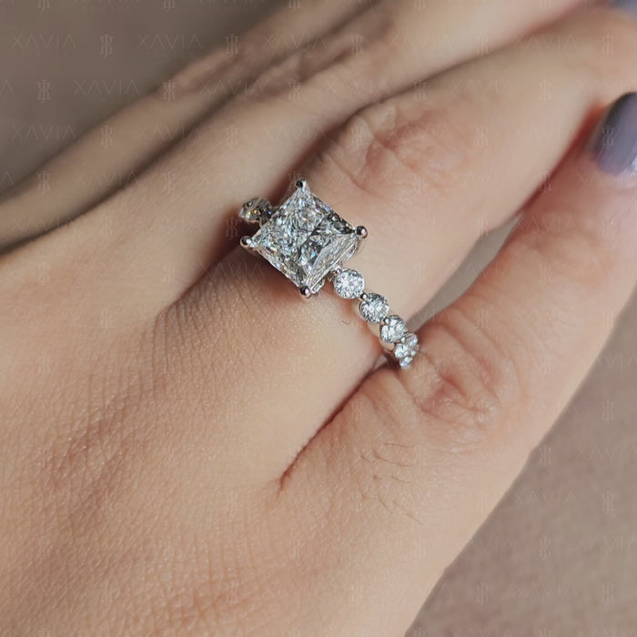 Front-facing view of princess cut lab diamond engagement ring with symmetrical four-prong setting and sparkling eternity-style