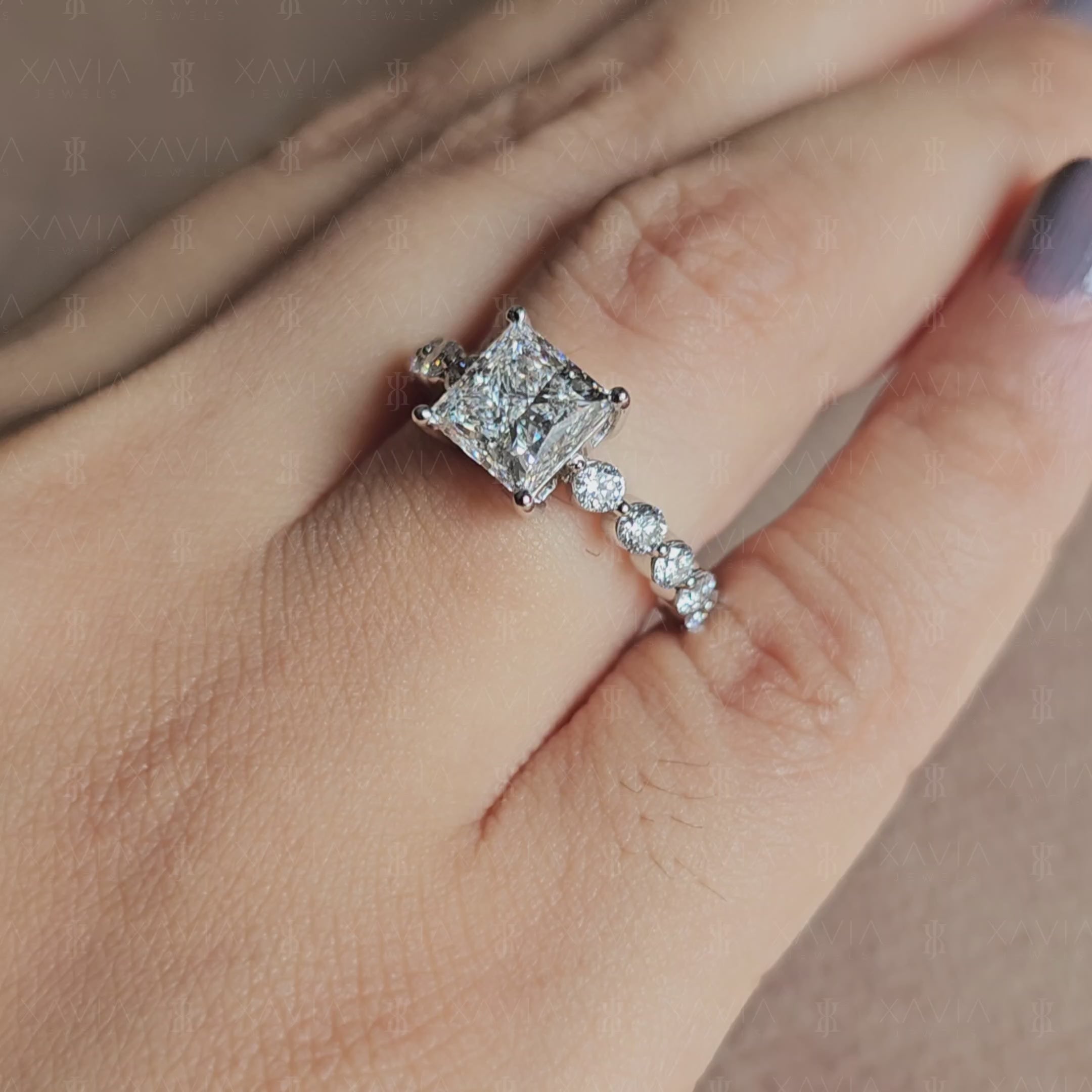 Front-facing view of princess cut lab diamond engagement ring with symmetrical four-prong setting and sparkling eternity-style