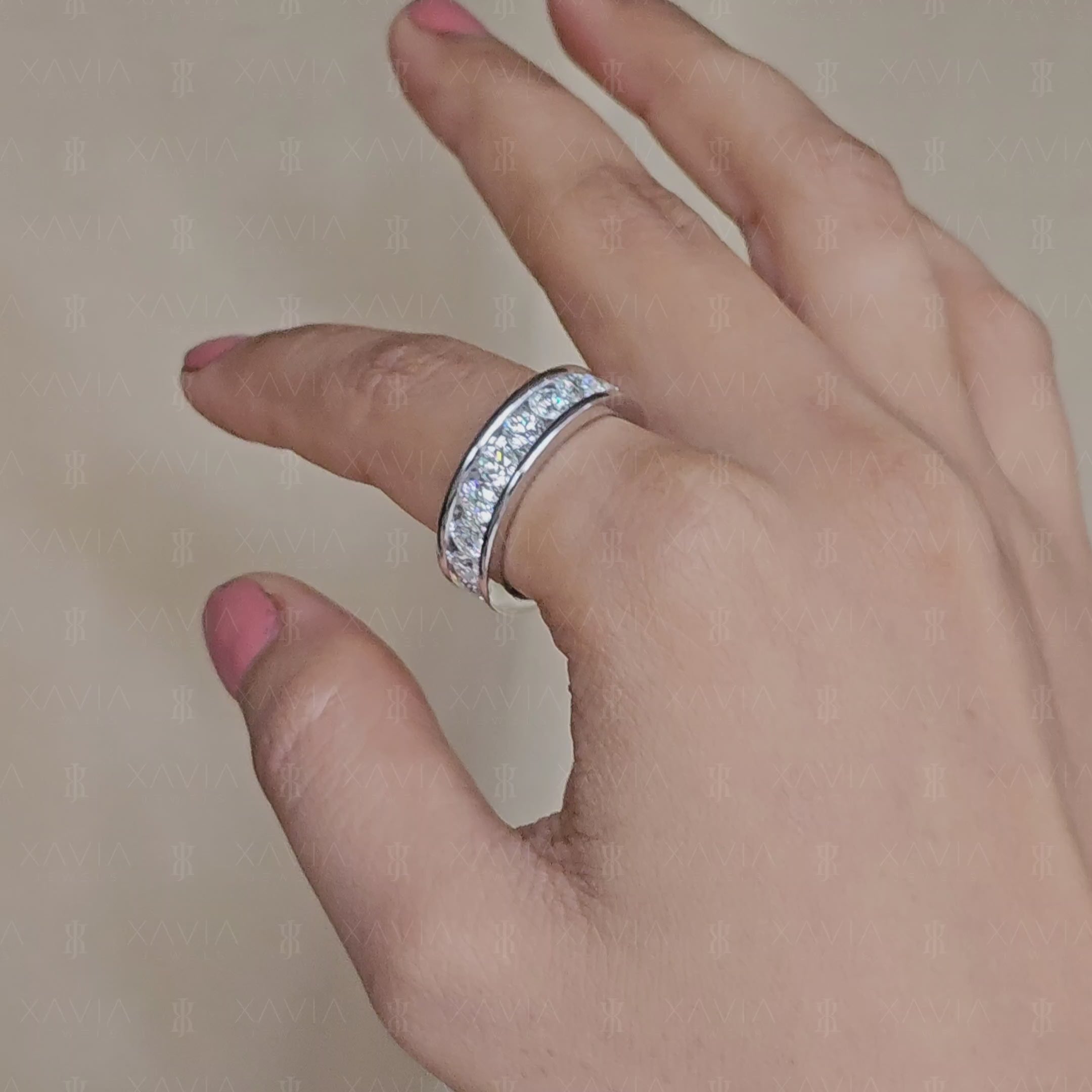 Luxury channel-set round diamond eternity band displayed inside velvet jewelry box with polished white metal 