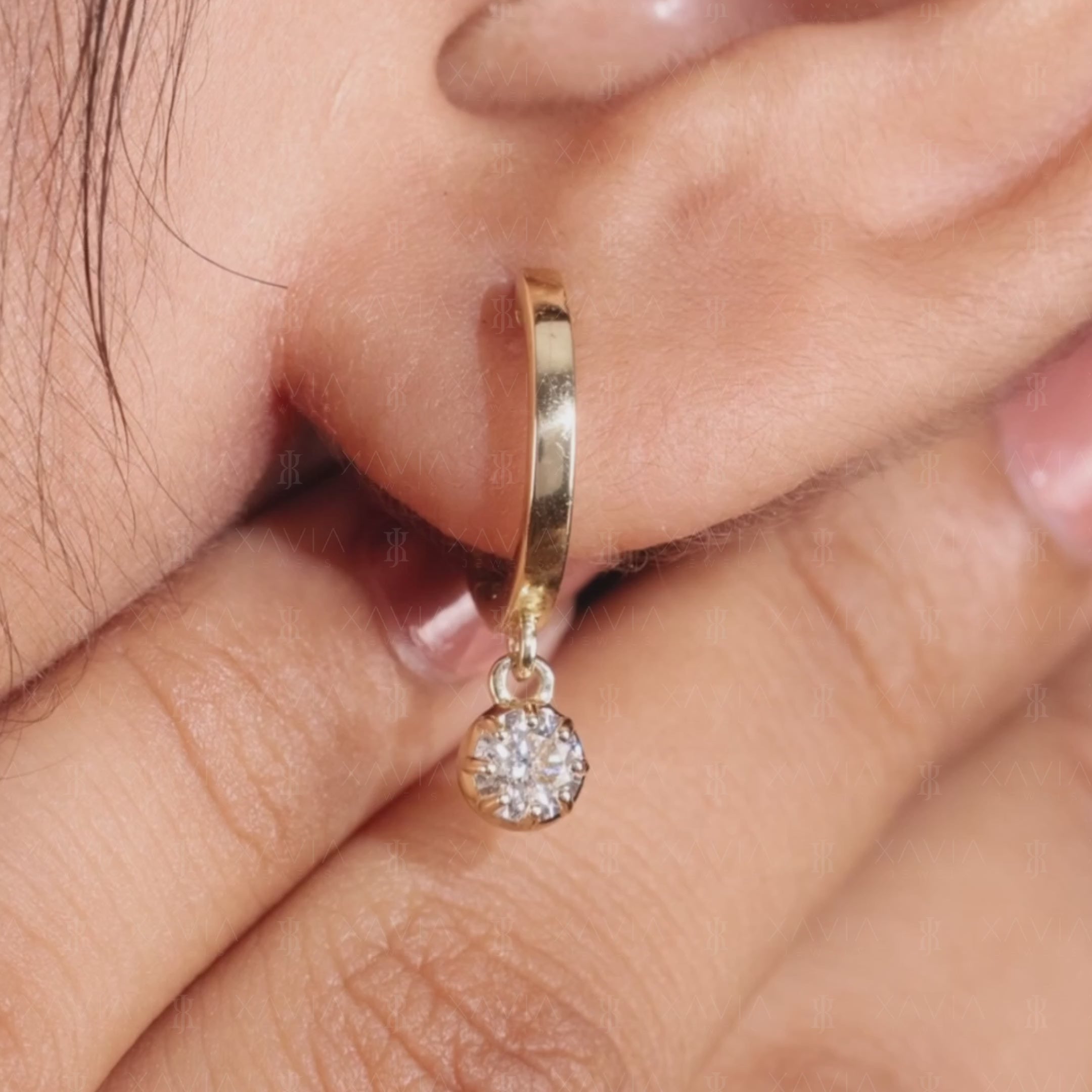 Close-up lifestyle image of polished yellow gold lab-grown diamond drop huggie earrings showcasing delicate round 