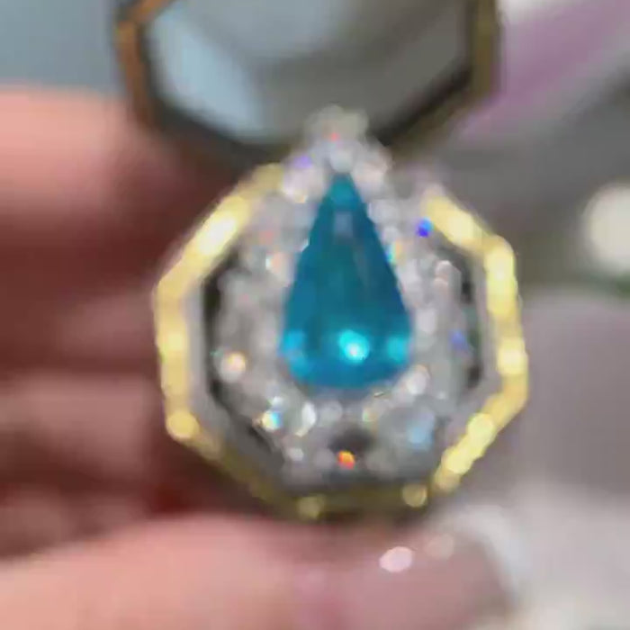 Azure Majesty – Pear Cut Blue Gemstone Halo Cocktail Ring with Marquise Diamond Cluster Setting and Dramatic High-Jewelry Statement Design