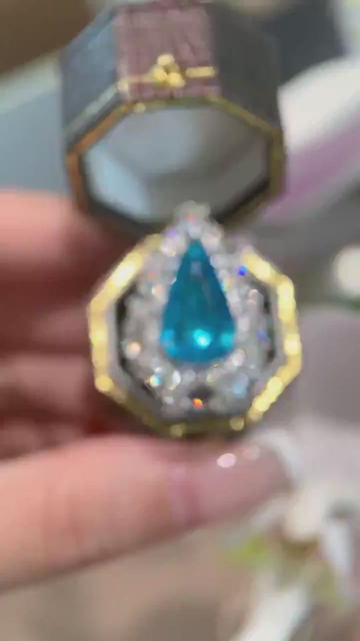 Azure Majesty – Pear Cut Blue Gemstone Halo Cocktail Ring with Marquise Diamond Cluster Setting and Dramatic High-Jewelry Statement Design