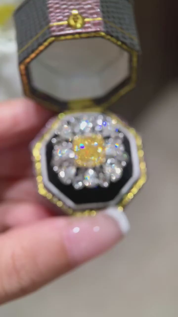model hand elegantly posing with cushion fancy yellow diamond cocktail ring featuring pear-shaped white diamond halo cluster design