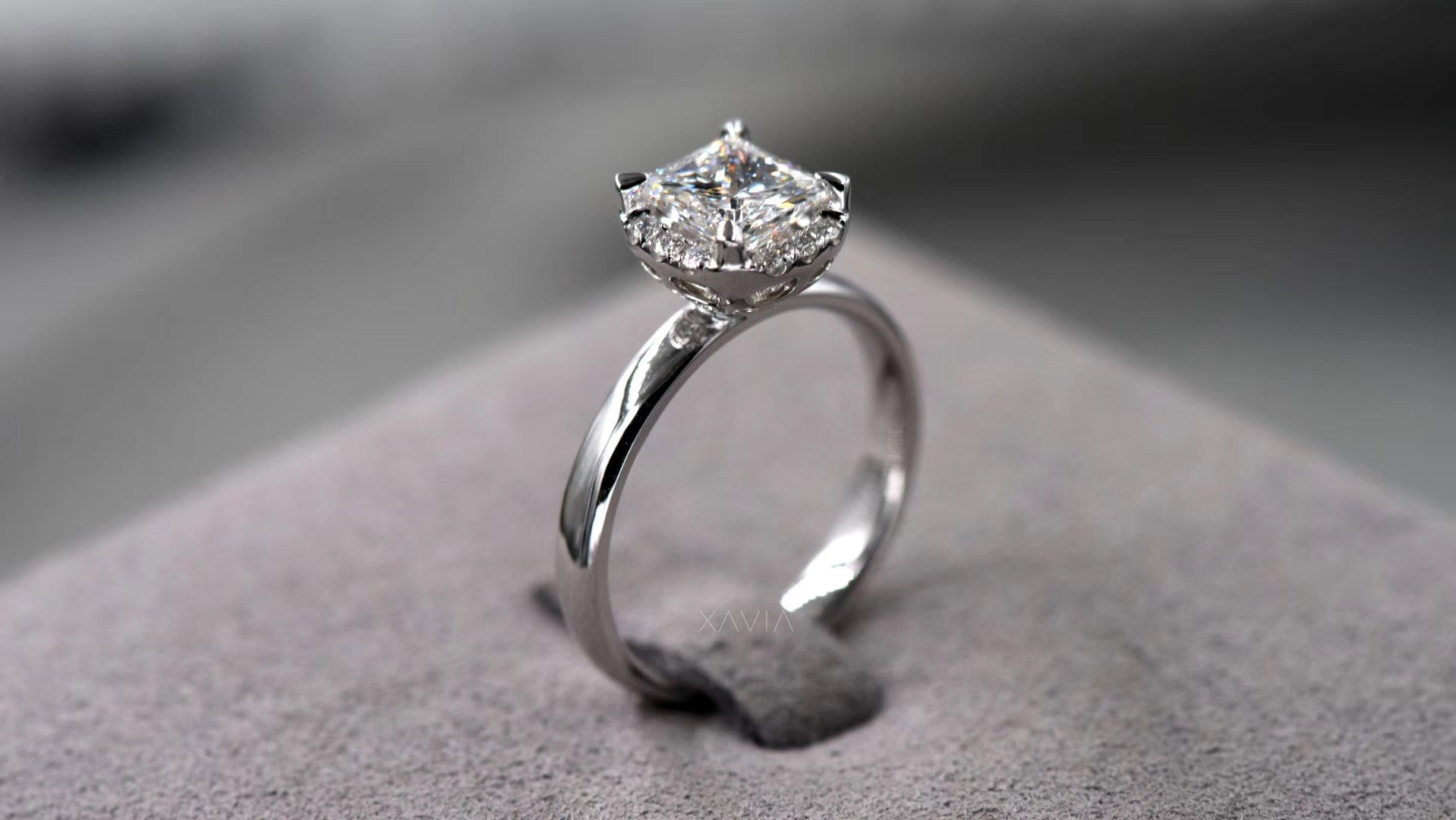 angled view of princess cut lab grown diamond engagement ring with crescent pavé halo accents and sleek high polish solitaire band in white metal