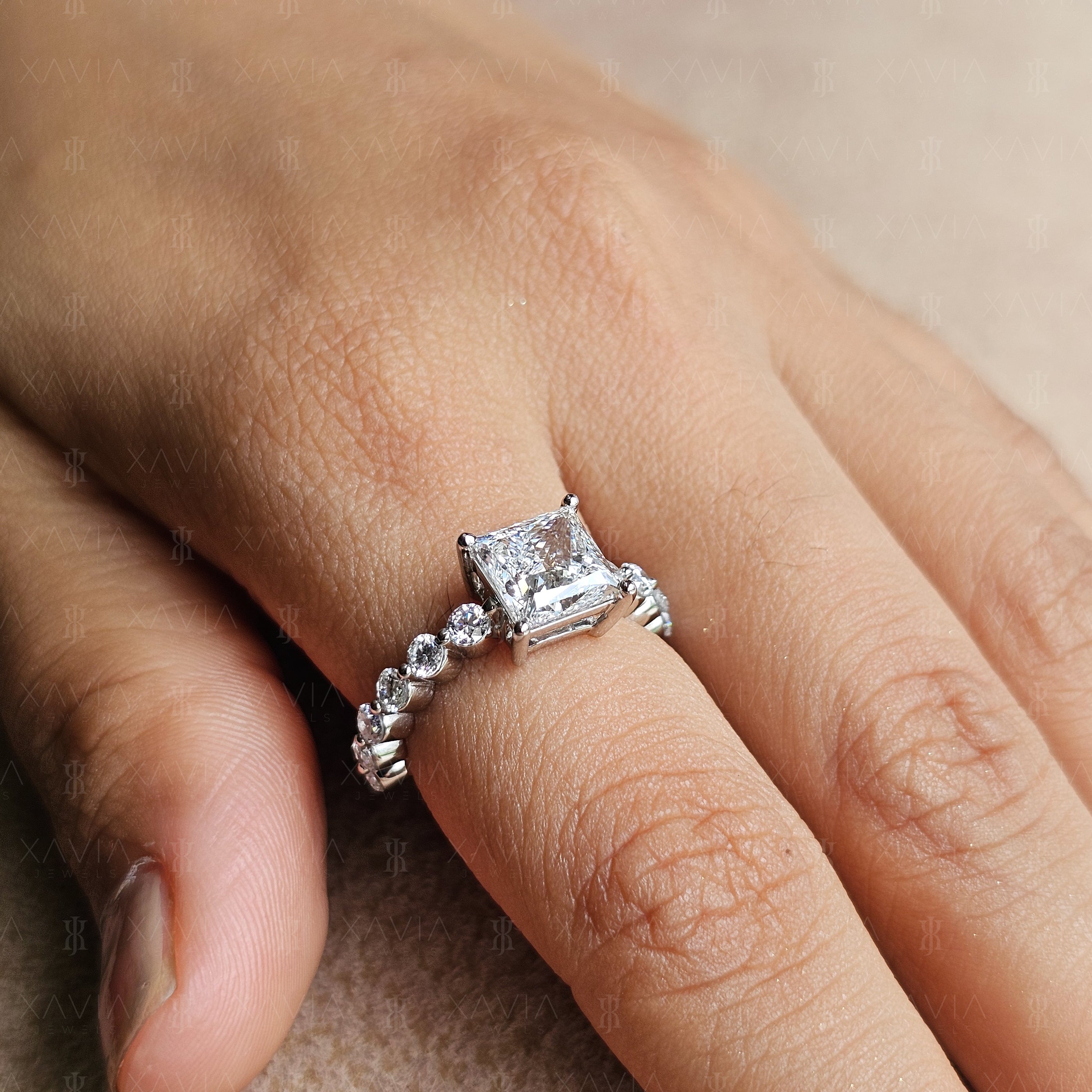 Side profile of princess cut lab-grown diamond engagement ring worn on hand with shared-prong round diamond eternity band and polished white metal