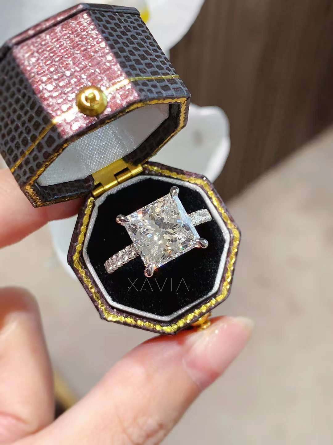 luxury princess cut lab grown diamond engagement ring displayed in elegant ring box featuring four prong cathedral solitaire setting and pavé diamond band
