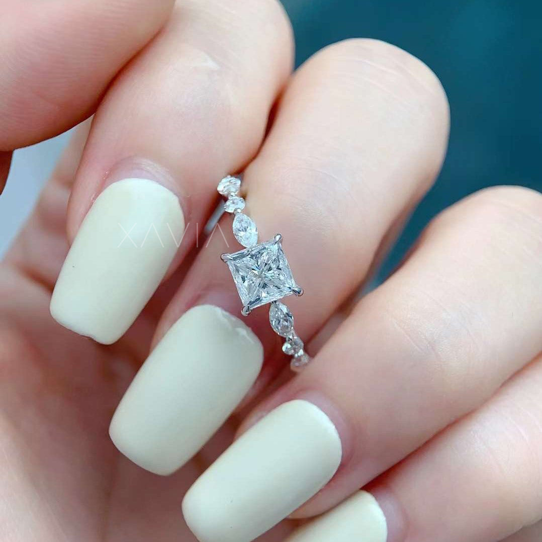 closeup angled view of princess cut diamond ring with marquise accents