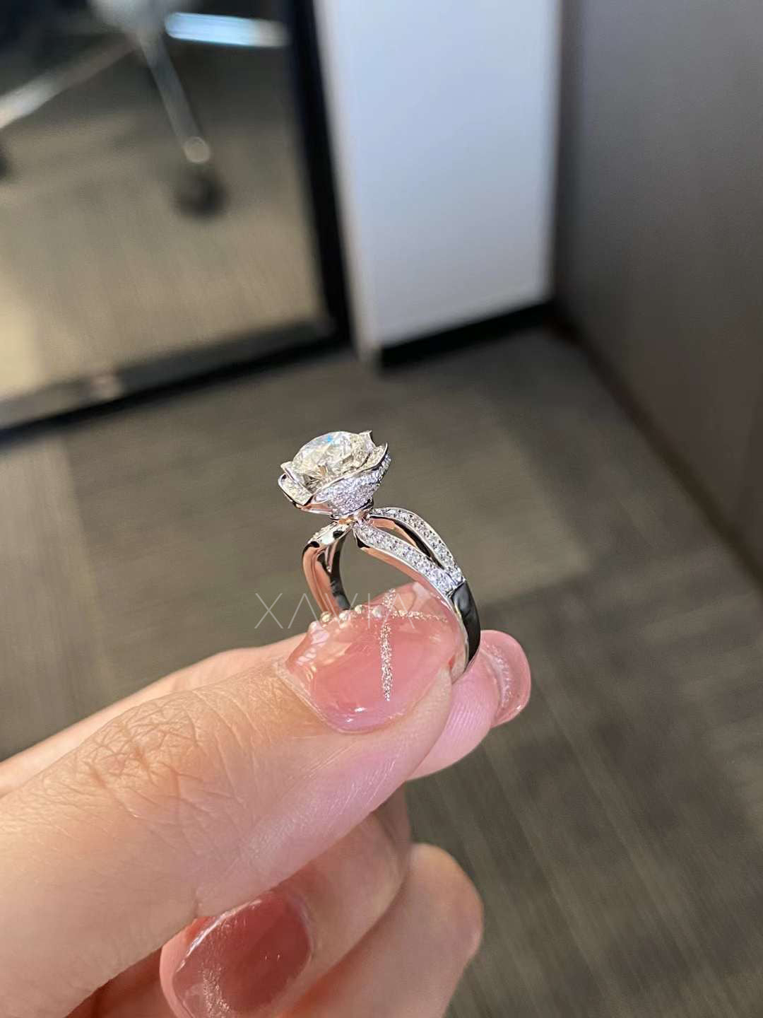 profile view showing round brilliant diamond halo ring with cathedral split shank pavé setting