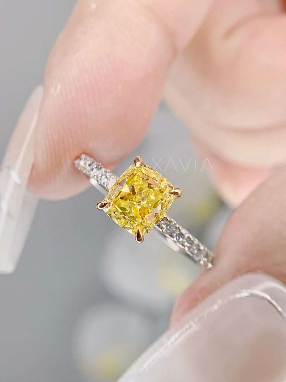 close-up of radiant yellow lab diamond ring with pavé band