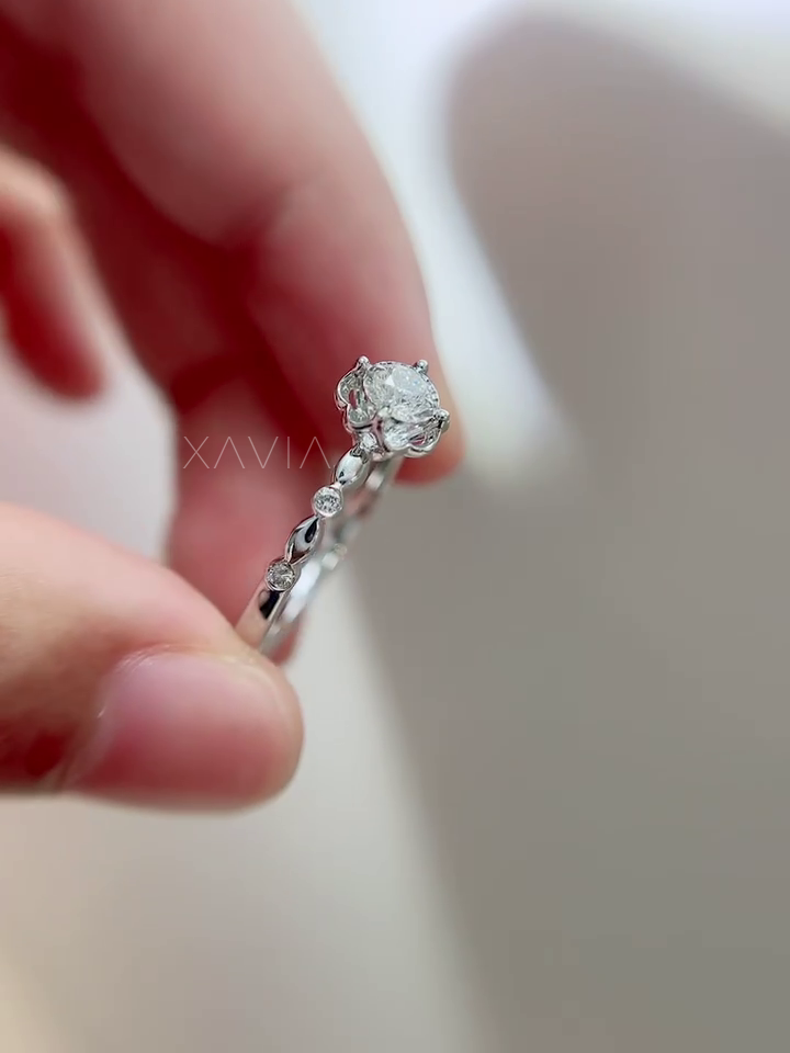 Side profile of Roselith engagement ring showing elevated floral halo basket, precise prong setting, and flowing diamond-accented band.
