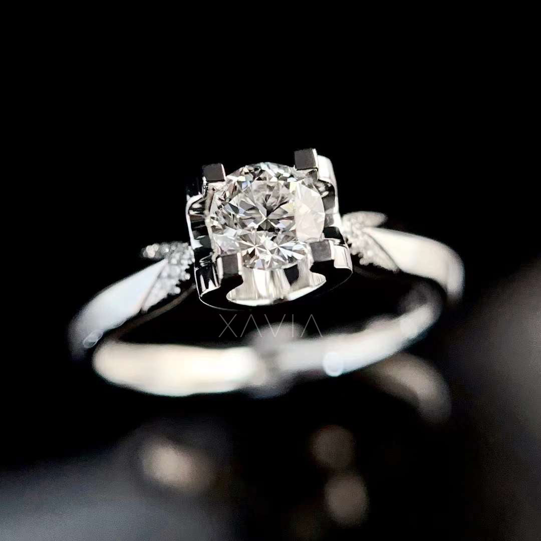 Top view of round brilliant lab grown diamond set in four prong solitaire engagement ring with refined split shank design