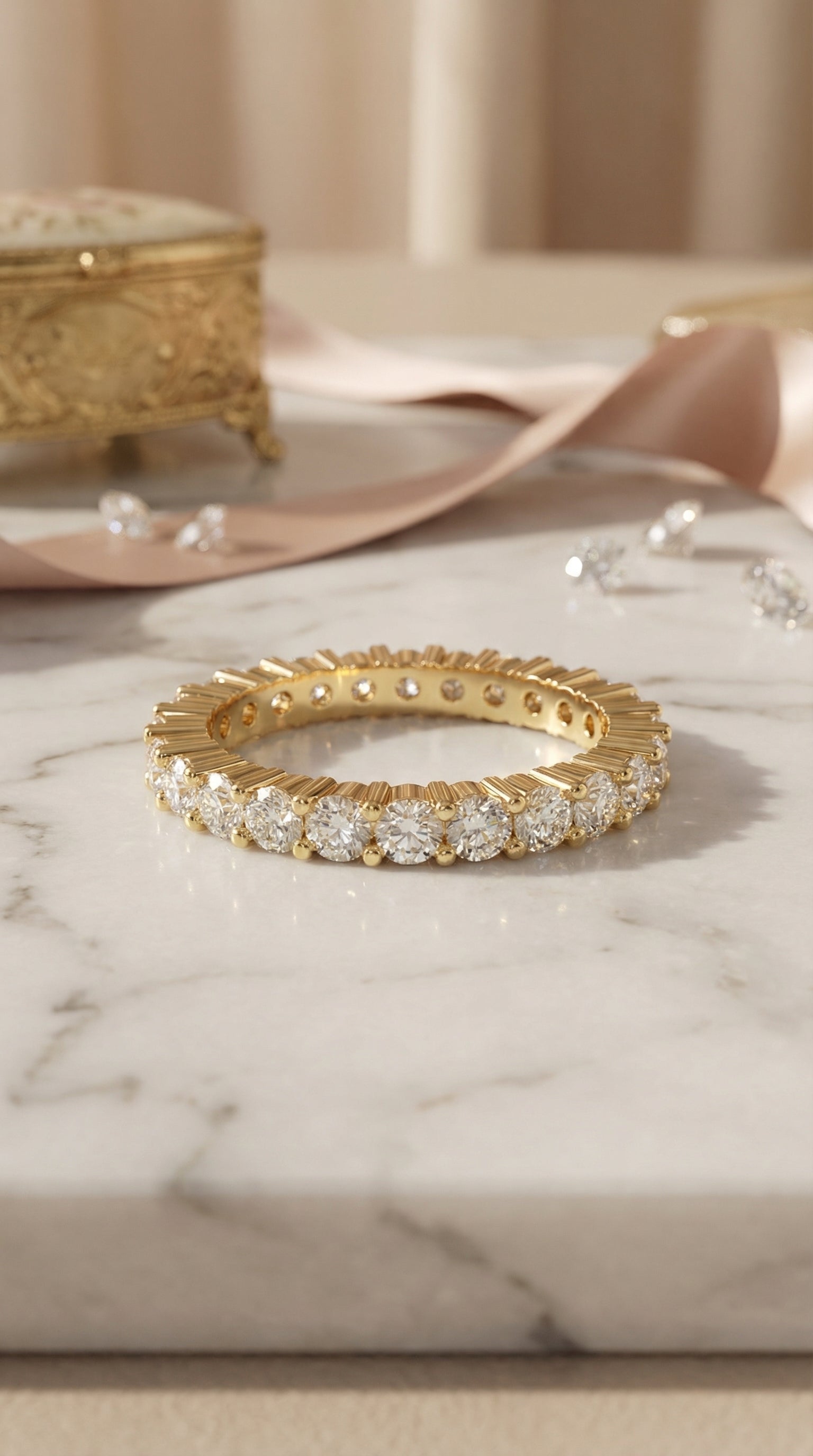 top view of round brilliant lab grown diamond eternity band in yellow gold with continuous diamond row and architectural fluted metal design placed on marble surface