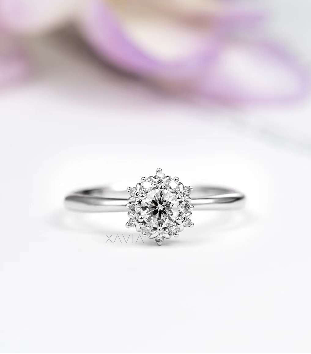 Front view of round cut lab grown diamond engagement ring featuring floral halo cluster and slim high polish white gold band