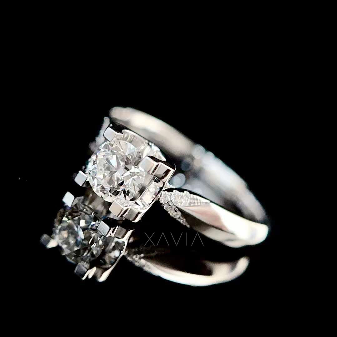 Luxury reflection shot of round brilliant lab diamond solitaire engagement ring showcasing crisp facets and sculptural white gold band