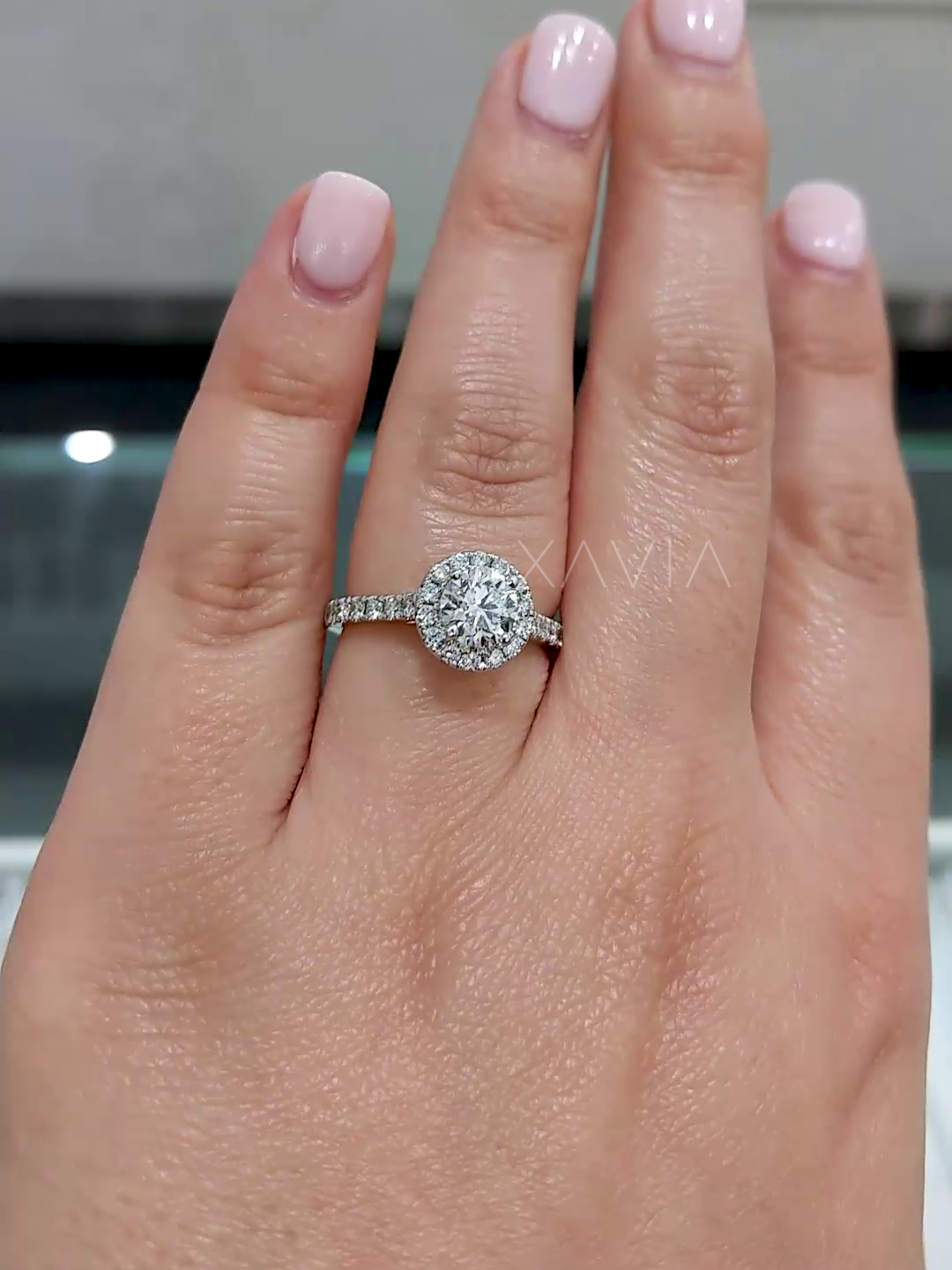 top angle showing round halo diamond with pavé band