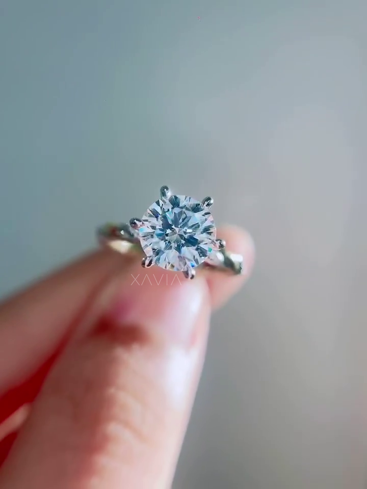 top view of round brilliant lab grown diamond solitaire ring with six prong setting showing symmetrical facets and classic engagement ring design