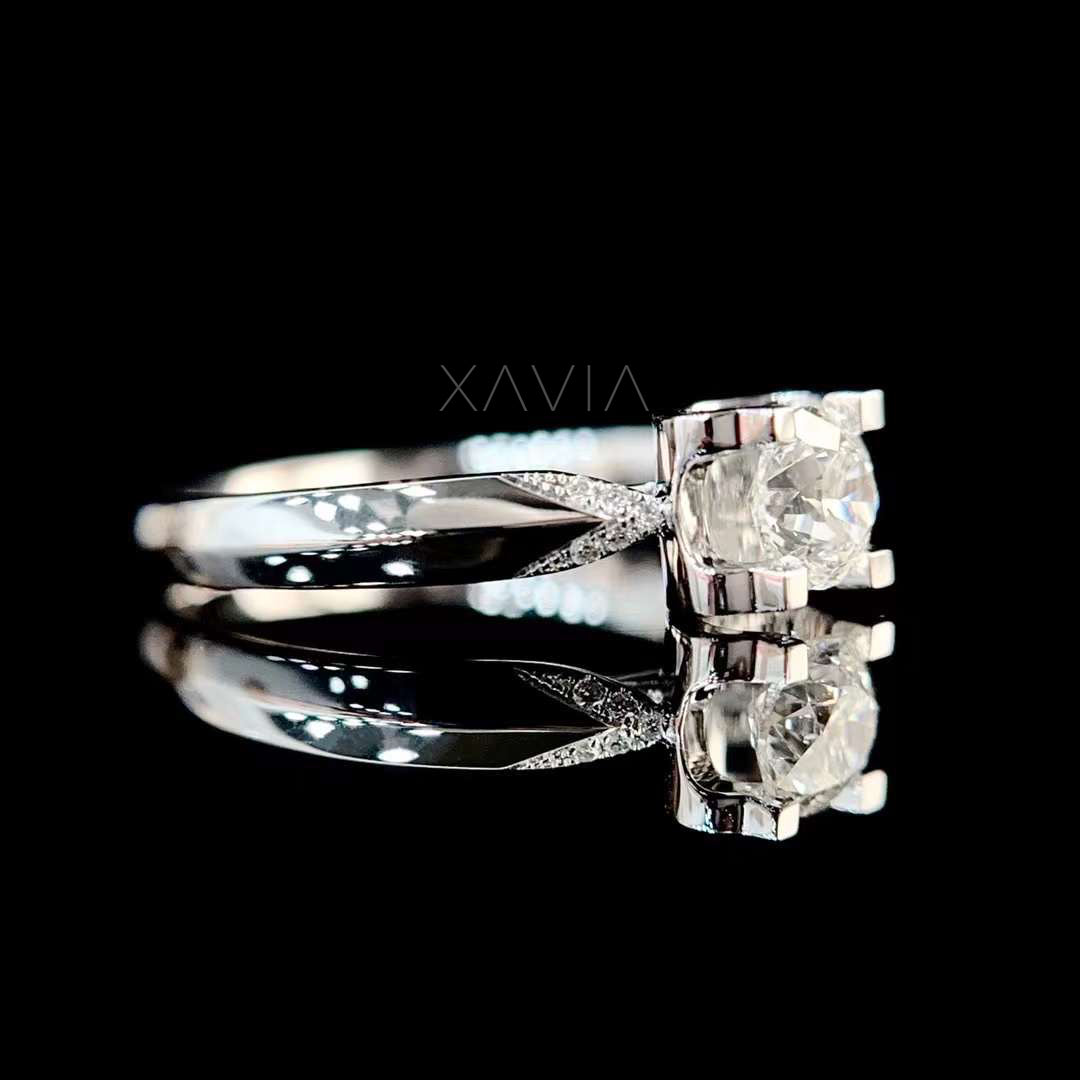 Side profile of round cut lab diamond solitaire engagement ring with sculpted split shank and pavé accents in polished white gold