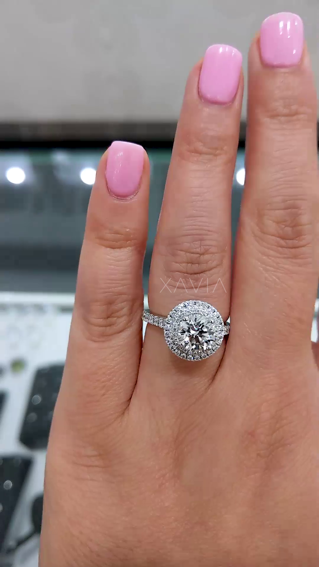 round brilliant lab grown diamond engagement ring with double halo and pavé band worn on hand showing high sparkle and symmetry