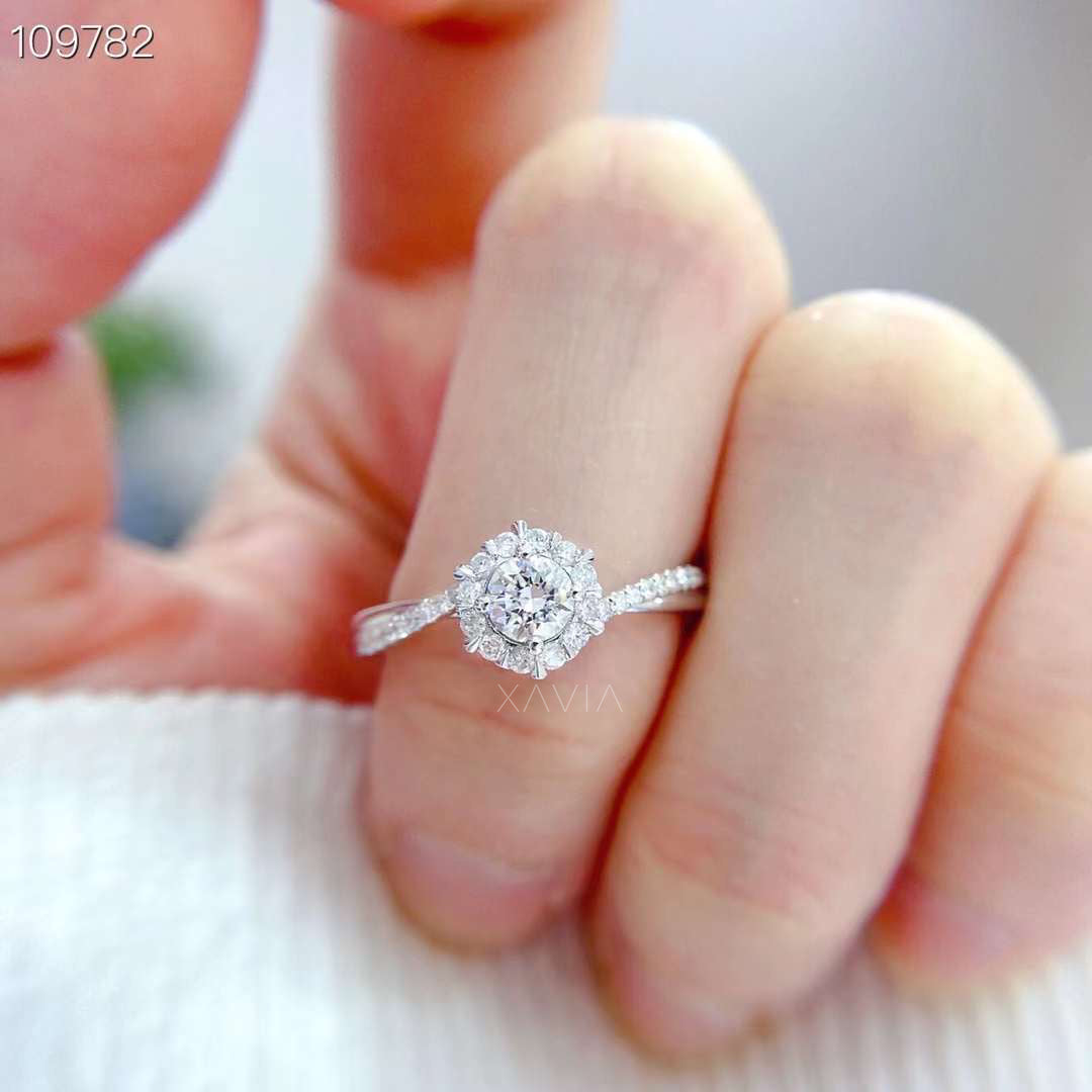 round cut lab grown diamond floral halo engagement ring worn on hand featuring marquise accents and pavé diamond band