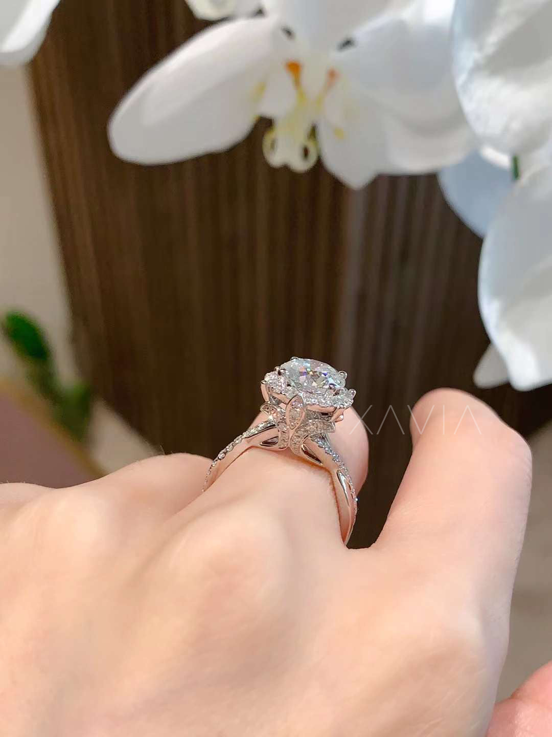 Diamond halo engagement ring paired with pavé eternity wedding band, shown stacked together in platinum finish with sparkling brilliance