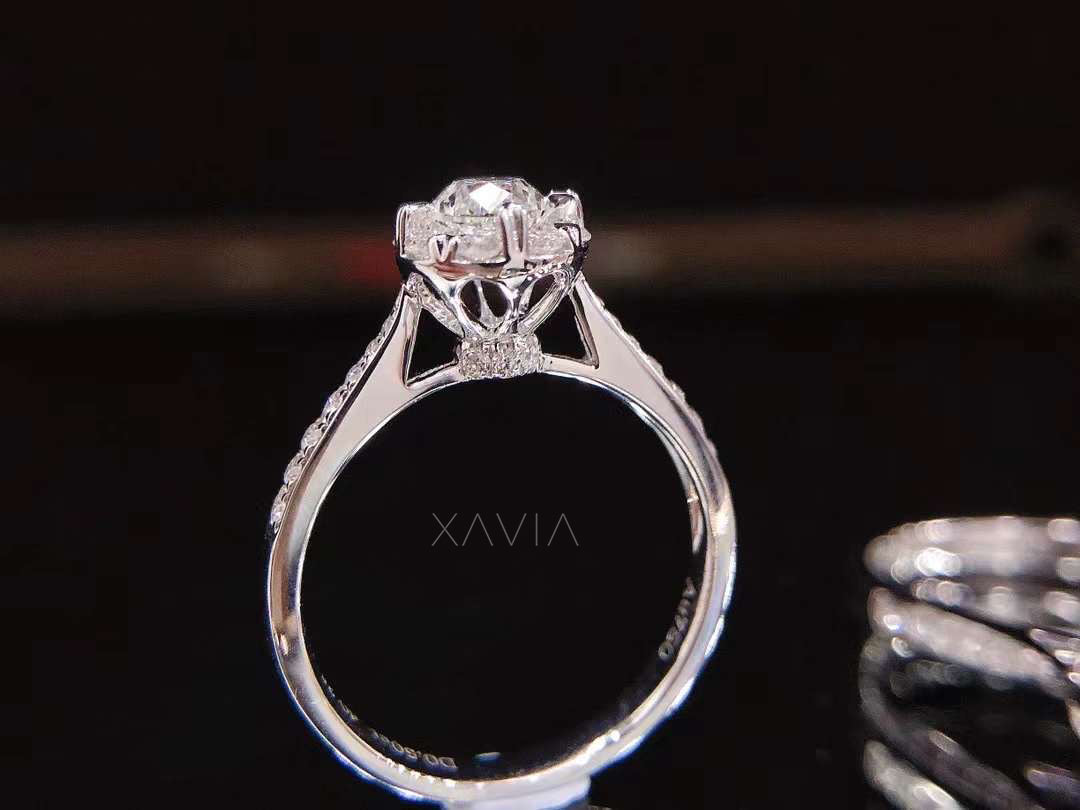 Close-up angled shot of round halo lab-grown diamond ring showing elevated center setting and detailed pavé shoulder craftsmanship